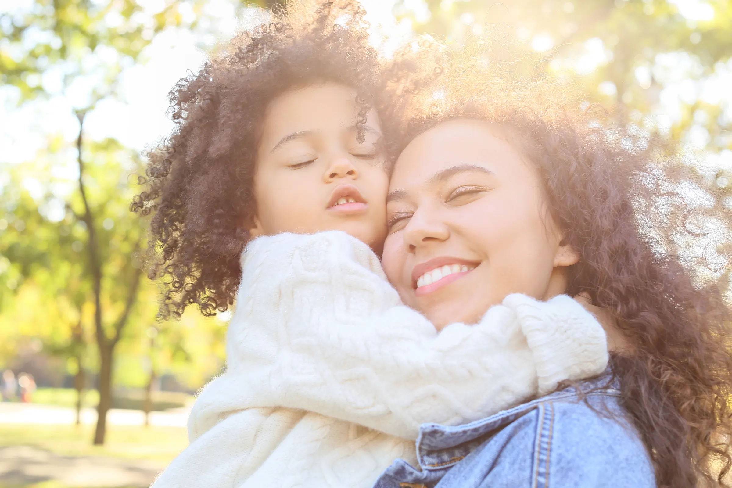 Mother and child embracing outdoors